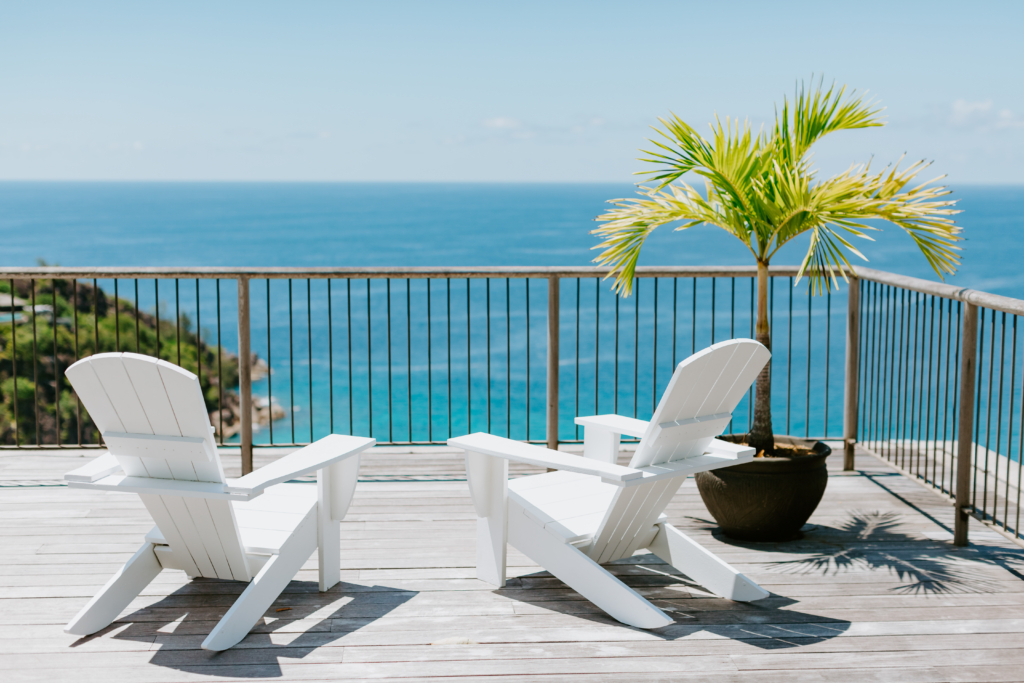 Ocean view terrace with white chairs – Spanish coastal property